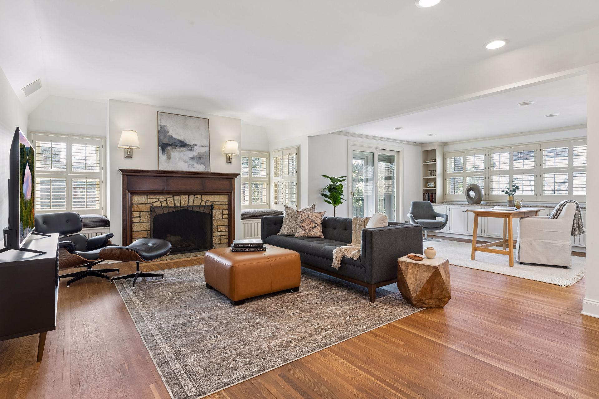 The inviting upper level sitting room is adjacent to the primary suite and includes an office area and three season porch.