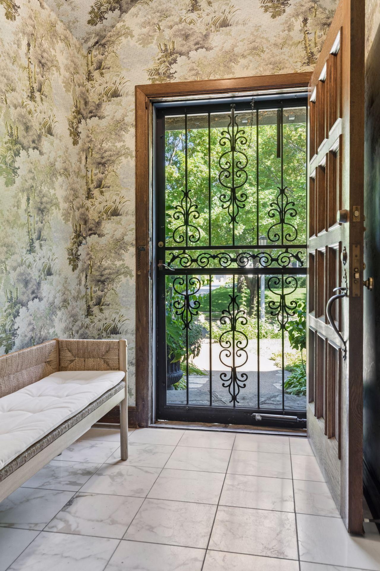 Gorgeous morning light fills the spacious foyer leading to a gracious entry hall.