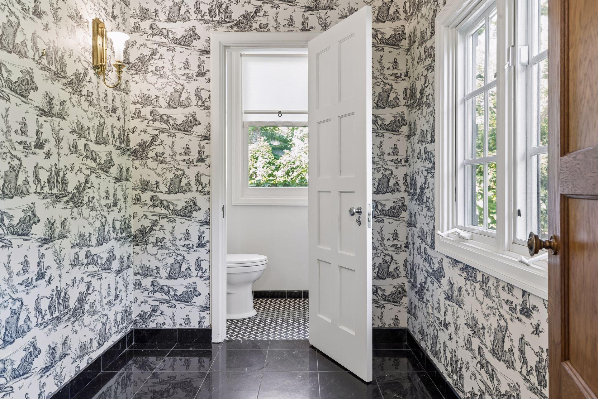 Main level powder room and lounge area adjacent to the front entry hall.