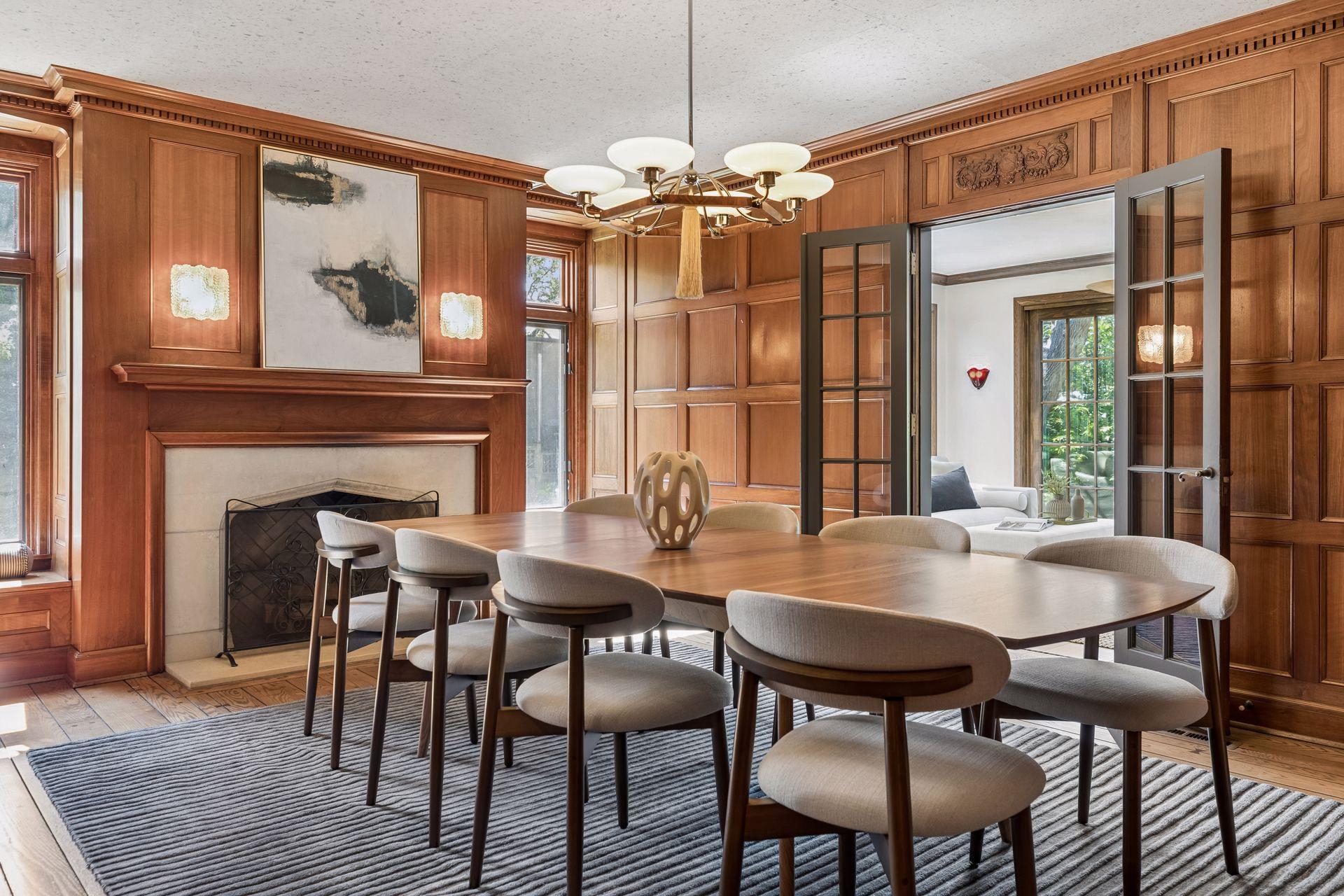 Window seats flank the fireplace in the formal dining room. French doors lead to the sunroom and patio.