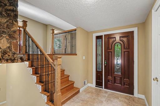 Large entry with attractive stairs leading to upper level