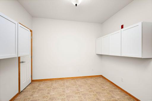 Another view of Flex room with built in shelves and door to more storage