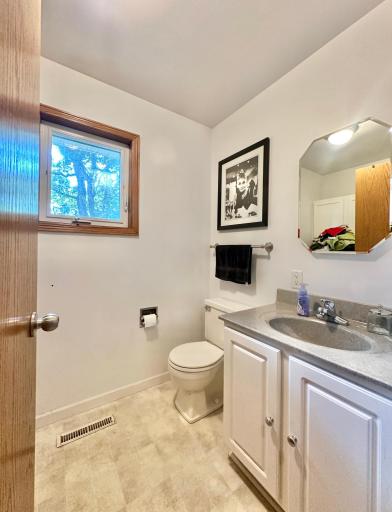 This convenient half bath on the main is located right off the garage and is also the laundry area.