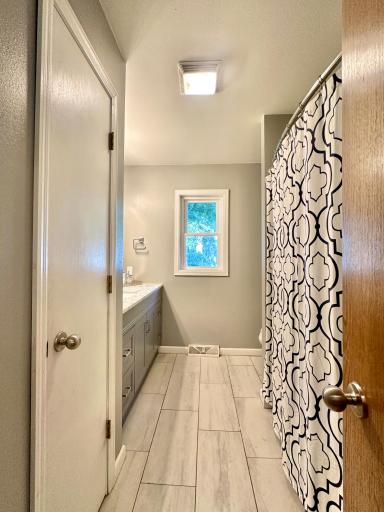 The second bath on the main is a full with solid surface counter top and tile floor.