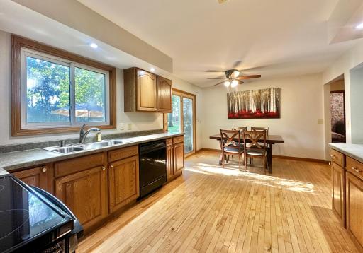 Morning sunshine floods this kitchen and the light colored wood floors reflect the daylight around.
