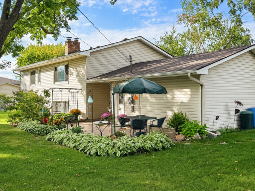 Relax with family and friends on the backyard patio, surrounded by perennials and blooming trees.