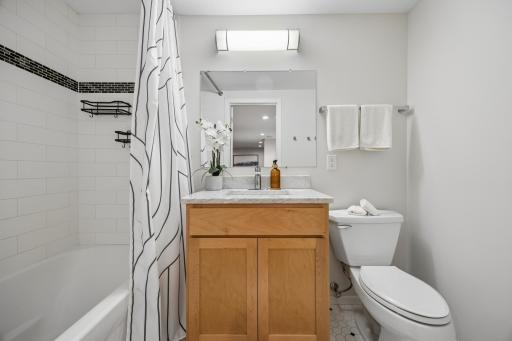 Lower-level full bath offering added convenience and functionality for guests and everyday living.