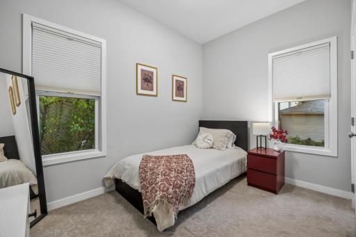 Second main-floor bedroom offering comfortable space and natural light.