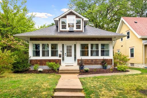 Classic Minneapolis bungalow with a welcoming front porch, well-maintained exterior, and mature landscaping.