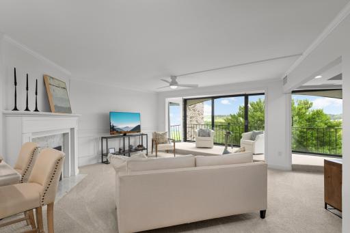 Living room with open porch and electric fireplace.