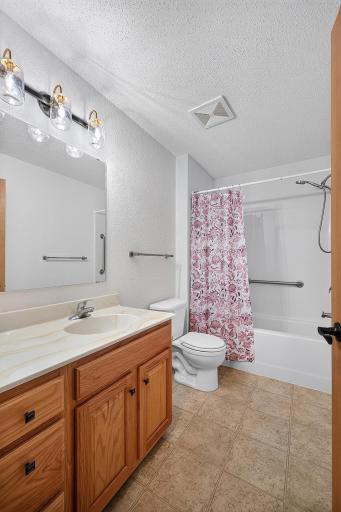 Second bathroom with tub, shower and oversized vanity.