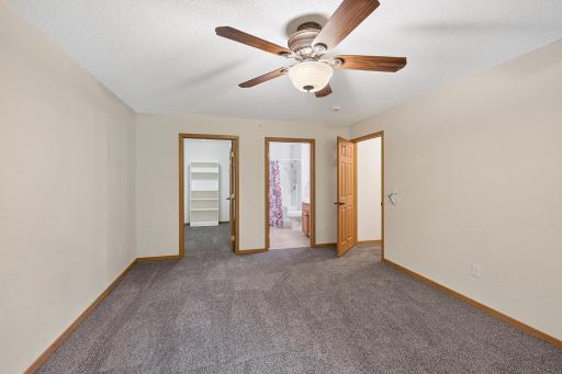 Primary bedroom facing large walk-in closet and private bath.