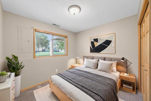 VIRTUALLY STAGED Lower level 3rd bedroom with custom window treatments.