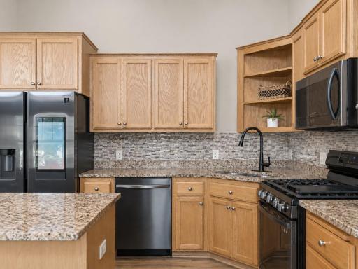 You'll love the premium stainless steel appliance package, featuring a gas range, smart refrigerator, dishwasher, and built-in microwave. I love the faucet, it ties in the updated kitchen.