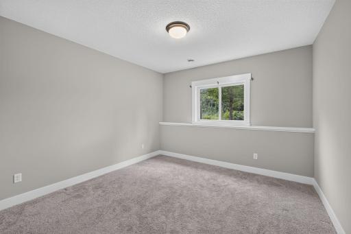 Lower-level bedroom offers a comfortable, private space for family or overnight guests