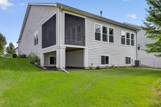 Rear exterior highlights the screened porch and spacious, beautifully maintained backyard