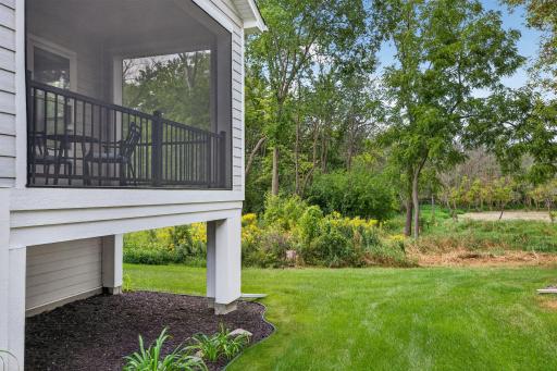 Peaceful backyard setting with wooded views and plenty of surrounding green space