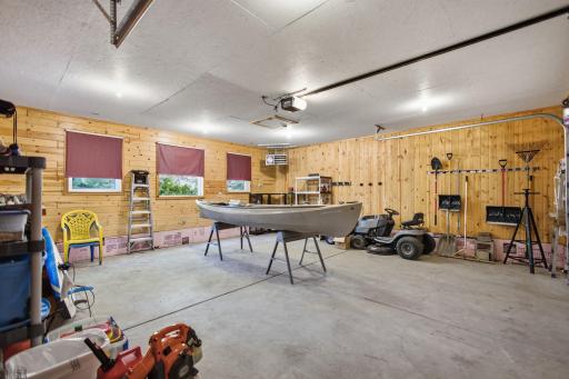 The heated garage, newer chimney, insulated, and fully dressed in knotty pine.