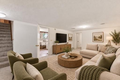 Virtual Staged lower-level family room showing options for room