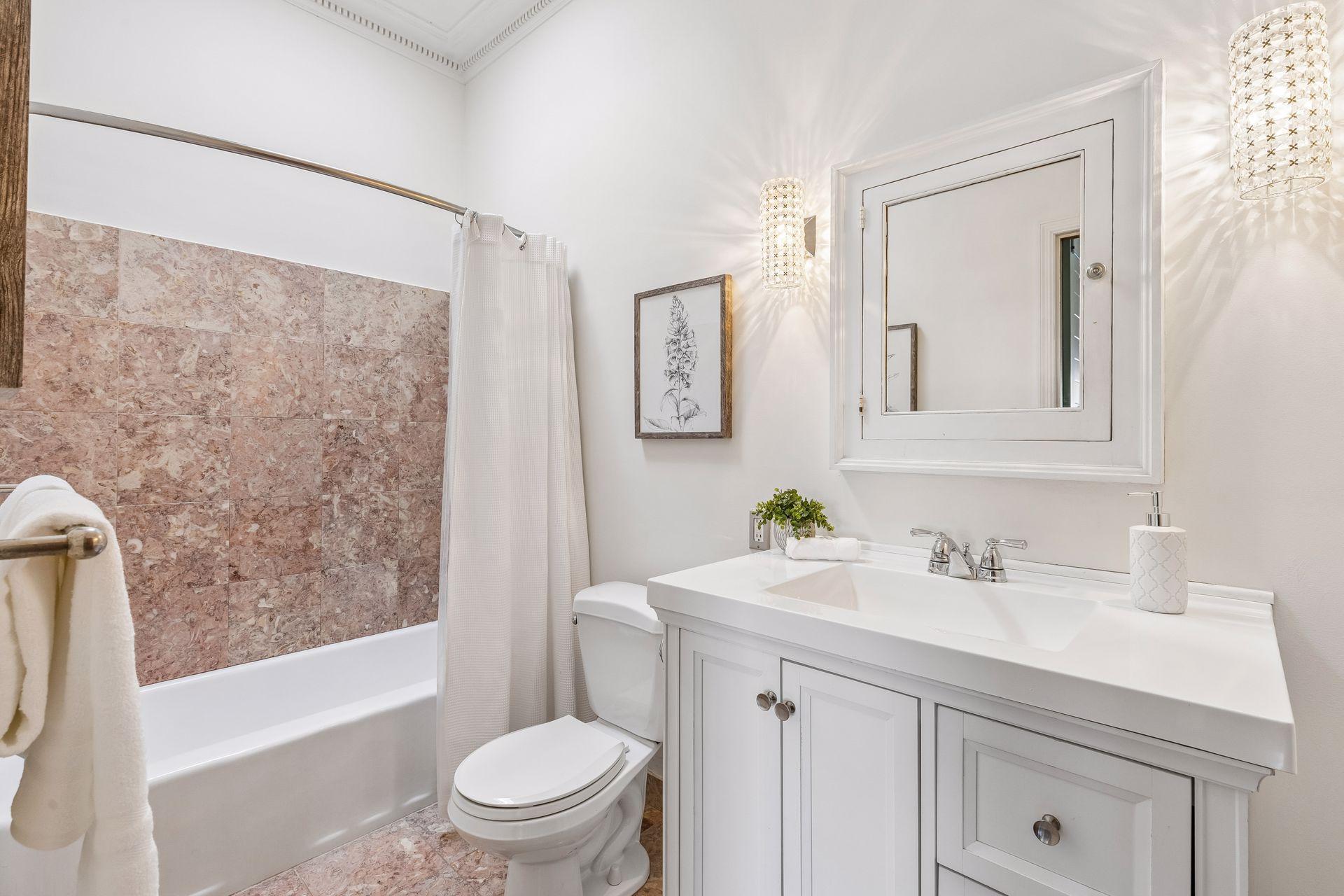 Full bathroom located just off of the primary bedroom and current area staged as an office.