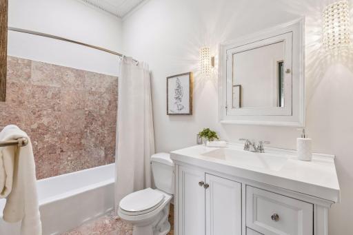 Full bathroom located just off of the primary bedroom and current area staged as an office.