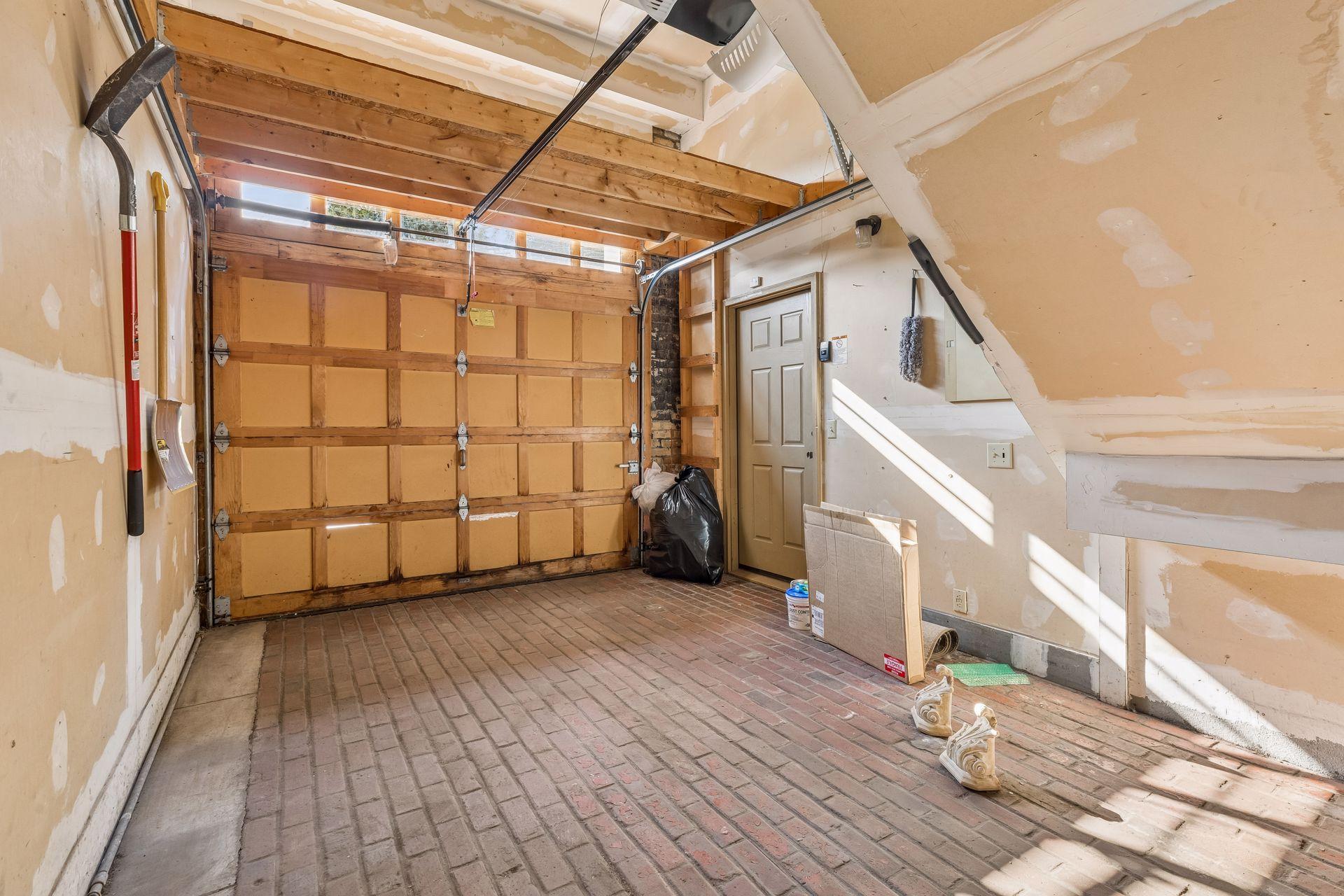 One car attached garage with authentic brick floor.