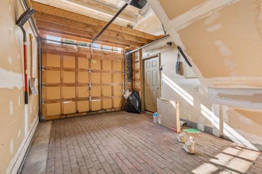 One car attached garage with authentic brick floor.