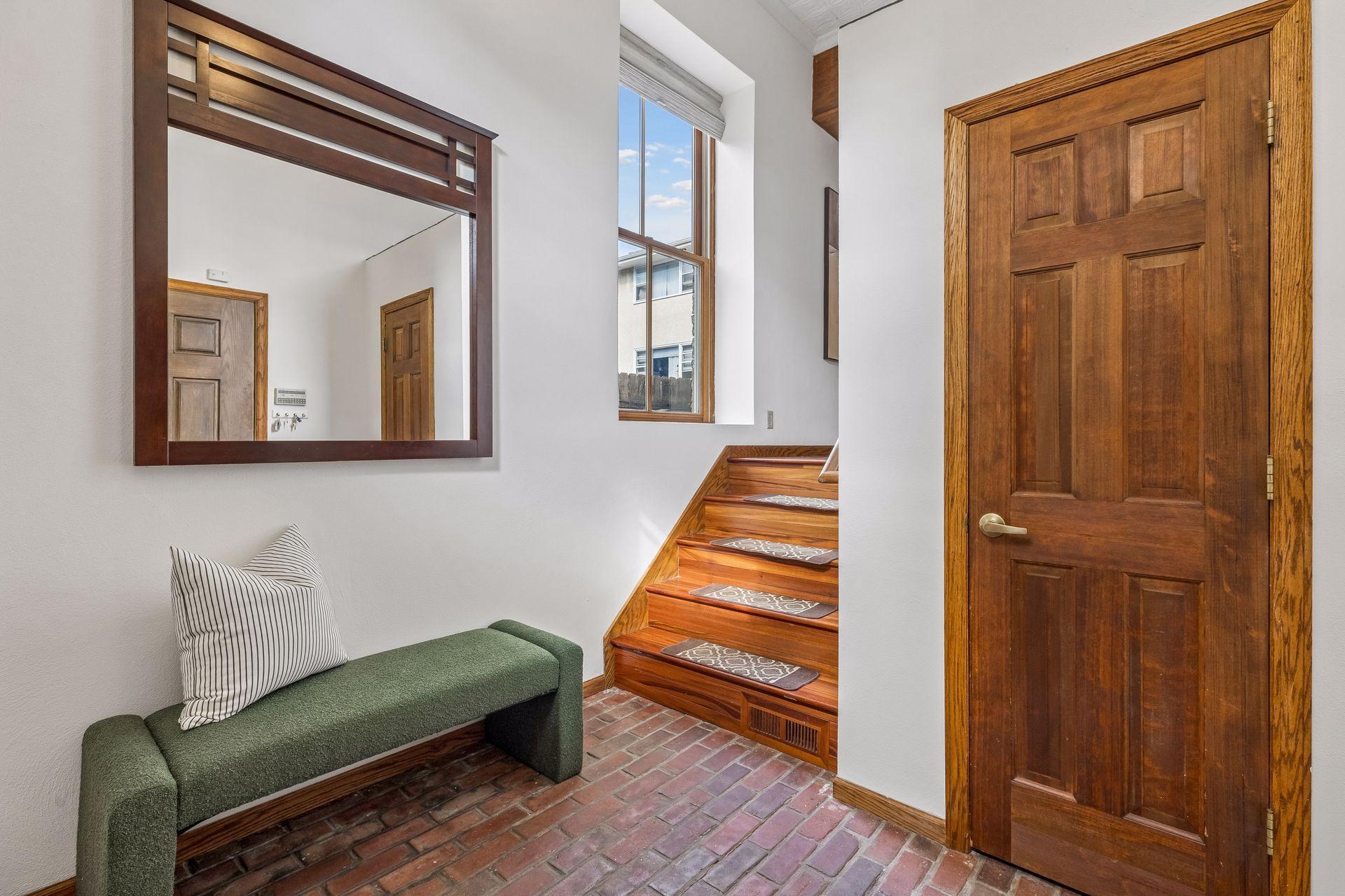 Convenient coat closet in the foyer. The brick floor just adds to the charm of this one-of-a-kind condo.