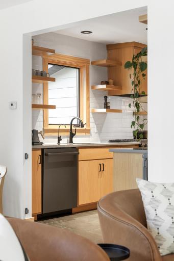 The kitchen connects effortlessly to the main level living and dining spaces