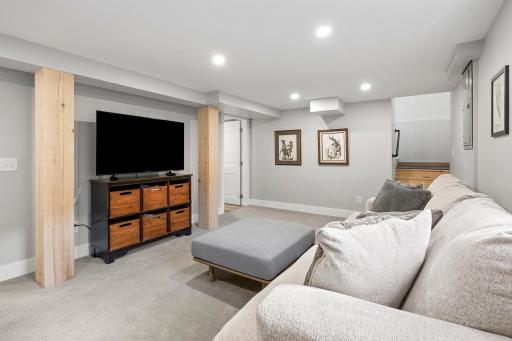 Clean, bright and cozy lower level family room includes new egress windows, recessed lighting and thoughtful finishes.