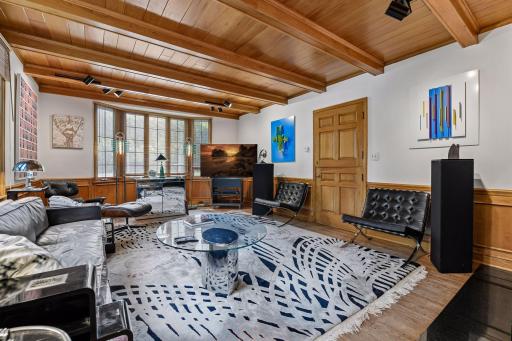 Warm and welcoming Main Floor Family room with Fireplace and walls of windows.