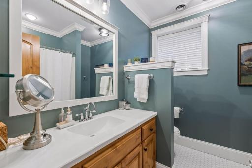 Lower-level bath with clean finishes, good storage, and a bright vanity area.