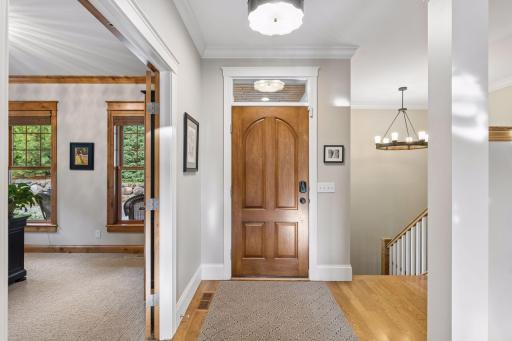 The foyer opens to warm hardwood floors and beautifully finished interior spaces.