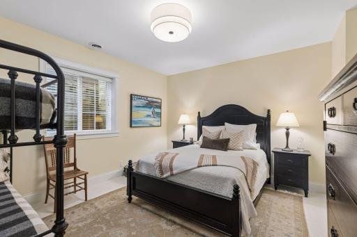 A comfortable lower-level bedroom gives guests privacy and their own dedicated space.