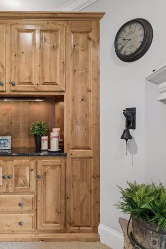 Built-in cabinetry adds warmth, organization, and display space beside the fireplace.