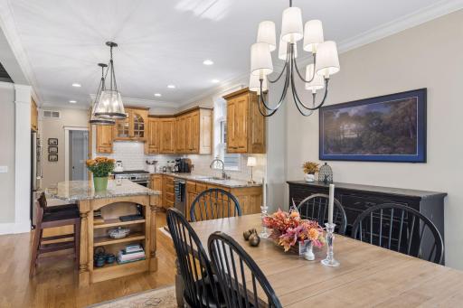 The dining room sits at the center of everyday life with the kitchen just steps away.