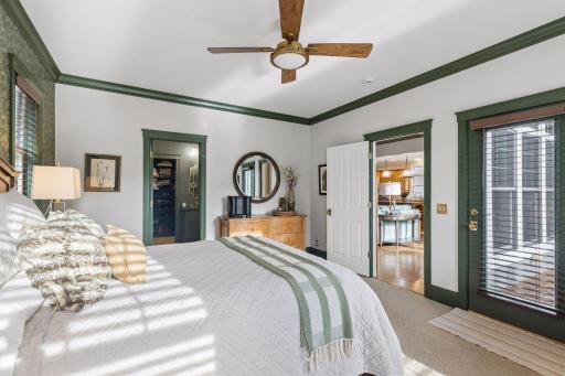 Green millwork and trim give the primary suite distinctive character.