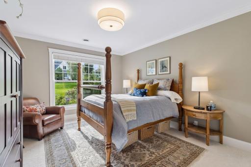 Another spacious bedroom with natural light and a warm residential feel.