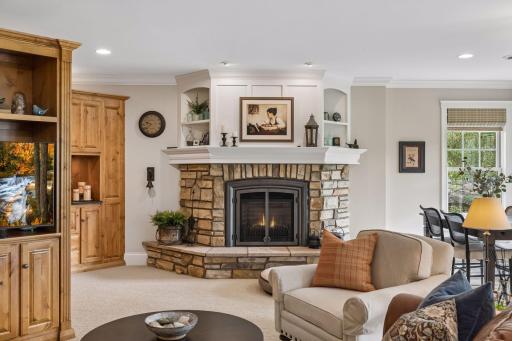 The second stone fireplace creates a warm focal point in the lower-level family room.