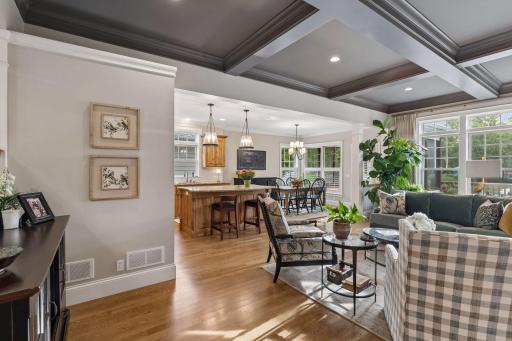 A bright transition space connects the foyer, kitchen, dining area, and living room.