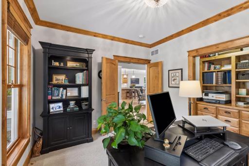 The main-floor office offers dedicated workspace with beautiful wood trim and built-ins.