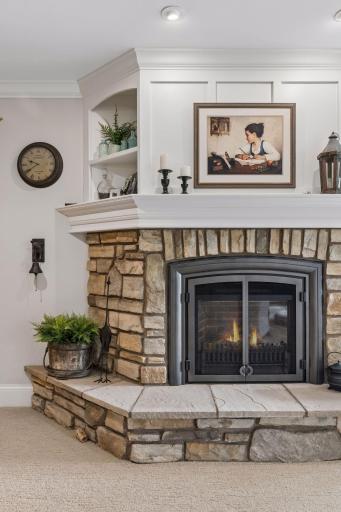 A closer look at the lower-level stone fireplace and traditional millwork.