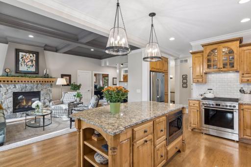 The kitchen sits at the center of the main level with warm knotty alder cabinetry and a generous granite island.