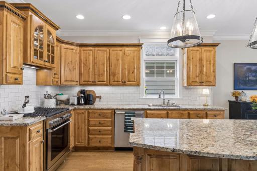 A closer view of the kitchenâs warm cabinetry, generous workspace, and timeless finishes.