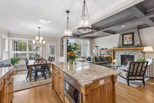A central island connects the kitchen naturally to the surrounding living spaces.