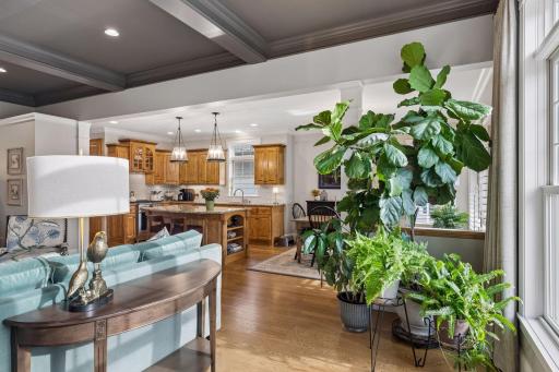 A beautiful connection between the living room, kitchen, and the homeâs lush surroundings.