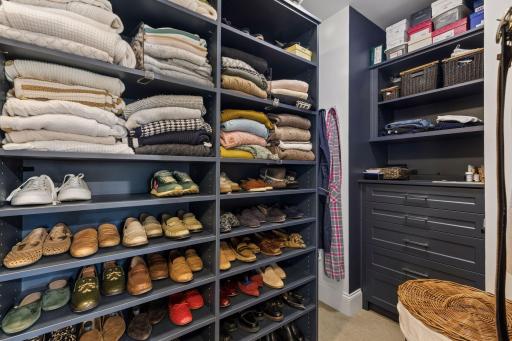 A well-designed primary closet with extensive built-in storage and organization.