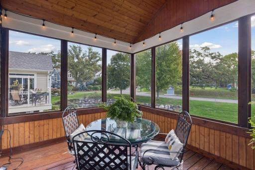 The screen porch is made for quiet mornings, evening dinners, and listening to the creek.