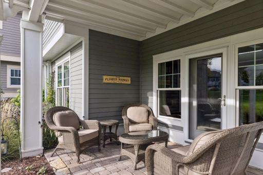The covered lower patio offers a quiet spot to sit just steps from the creek.