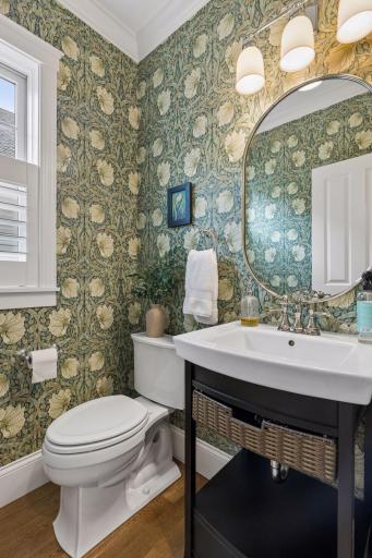 Main-floor powder bath with classic finishes and a charming, collected feel.